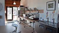 Luxurious, commercial kitchen with espresso machine, gas range and beer taps
